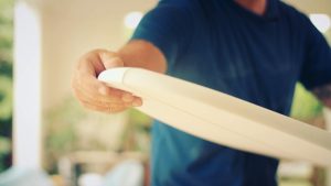 Hand shaping a single fin surfboard during covid-19 pandemic