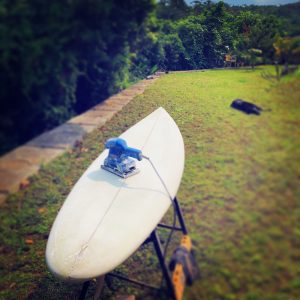 Hand shaping a single fin surfboard during covid-19 pandemic