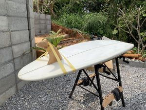 Hand shaping a single fin surfboard during covid-19 pandemic