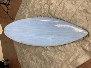 Hand shaping a single fin surfboard during covid-19 pandemic